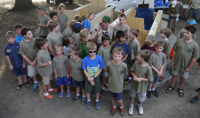 Our boys enjoying a song before our rain gutter regatta. (This is only 1/3 of our boys.)